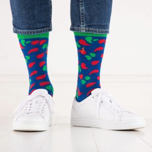 close up of person wearing red, green and blue patterned socks