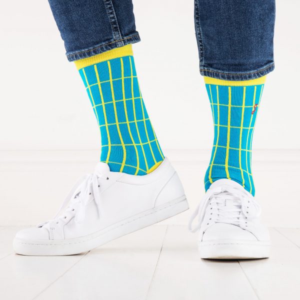 close up of person wearing yellow and blue patterned socks