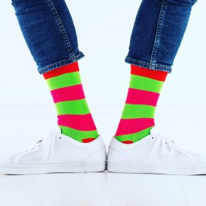 close up of person wearing pink and green patterned socks